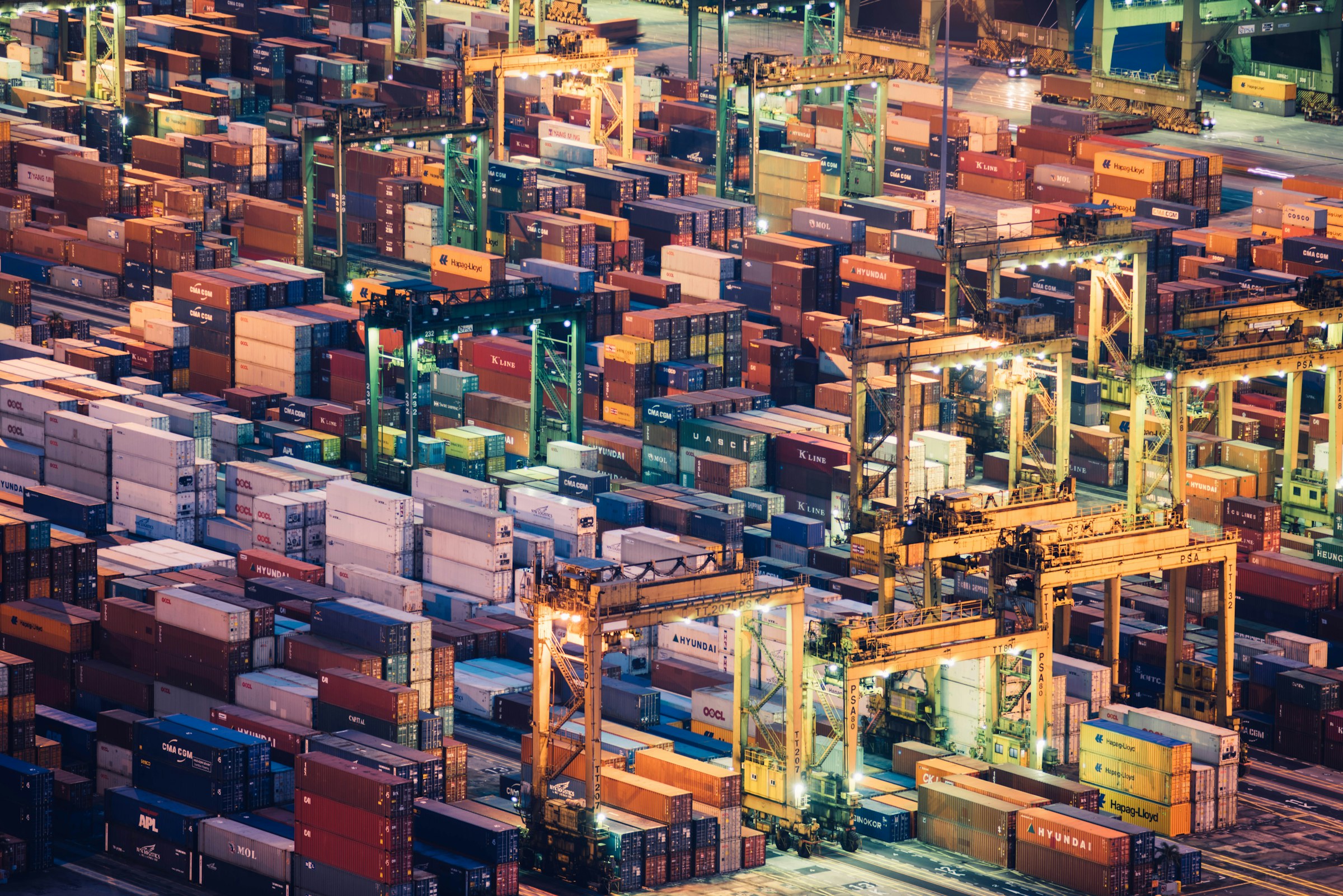 Container terminal at dusk with stacked freight